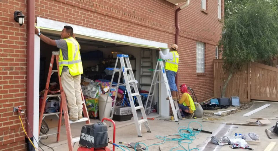 Installers lifting Garage lintel with LintelLift | MDH Foundation Repair